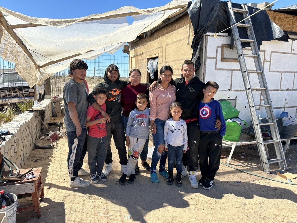 Family standing together in front of a home in Puerto Peñasco